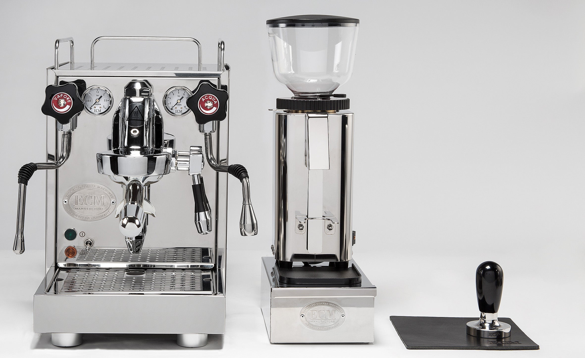 ECM Mechanika Slim VI espresso machine beside an ECM grinder and knock box drawer
